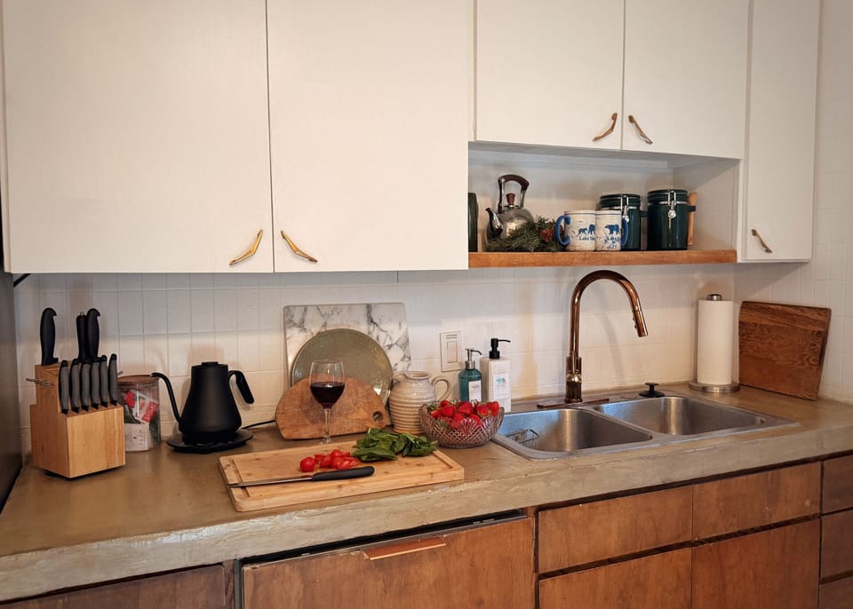 Warm, modern kitchen with double sink and thoughtfully styled prep space