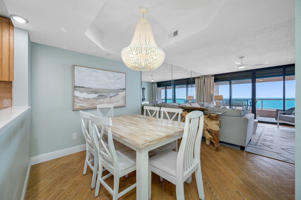 Elegant dining setup with stunning gulf scenery.