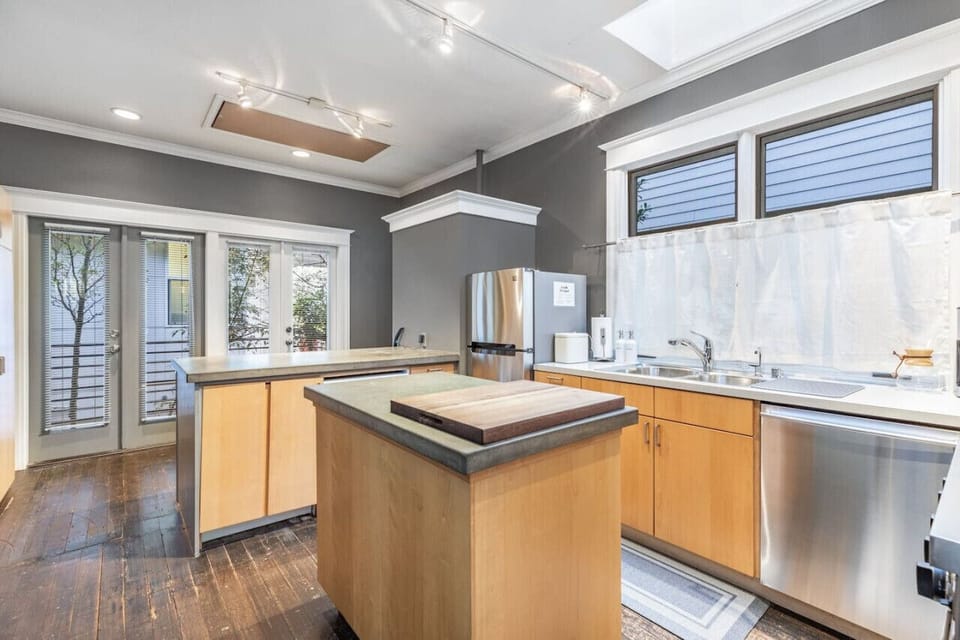 Well-lit kitchen with a cozy island and modern design.