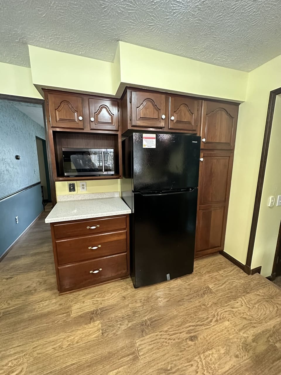 Full size refrigerator and microwave.
