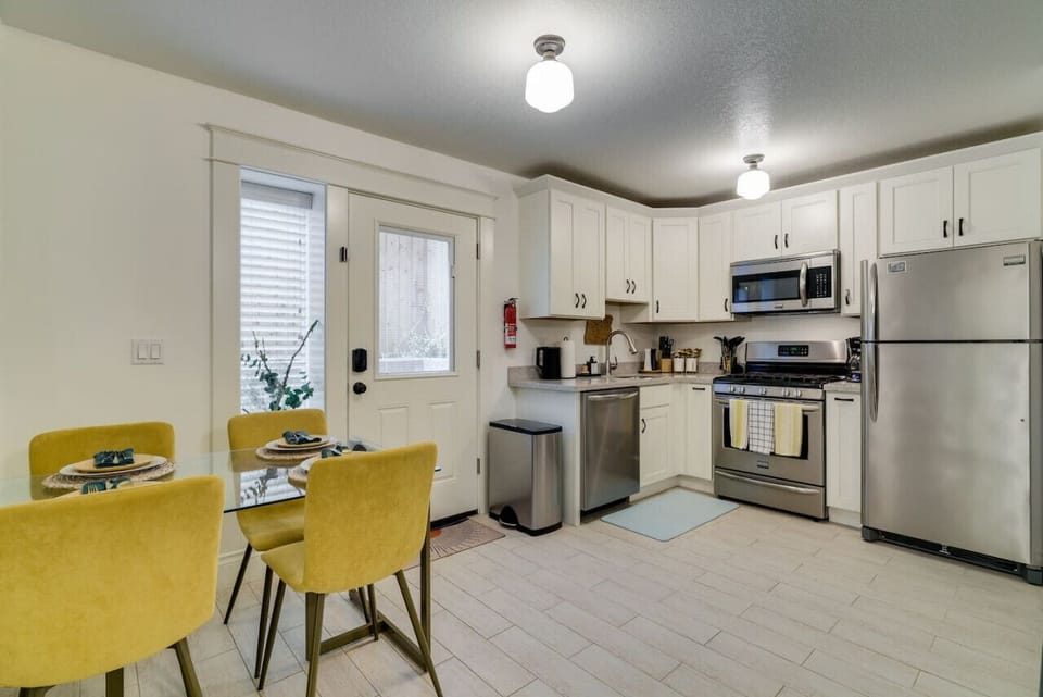 The kitchen is fully equipped with stainless steel appliances including a gas stove, microwave, dishwasher, refrigerator, Ninja blender, and toaster.