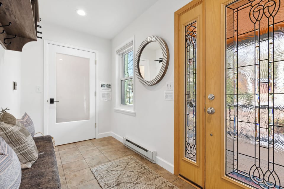 Entry foyer with half bathroom and room for shoes and coats