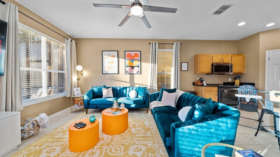 Cozy living rom with ceiling fan and plush couches
