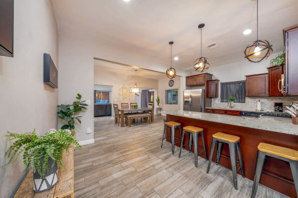 Spacious kitchen with stainless appliances, flowing into the dining area and living room