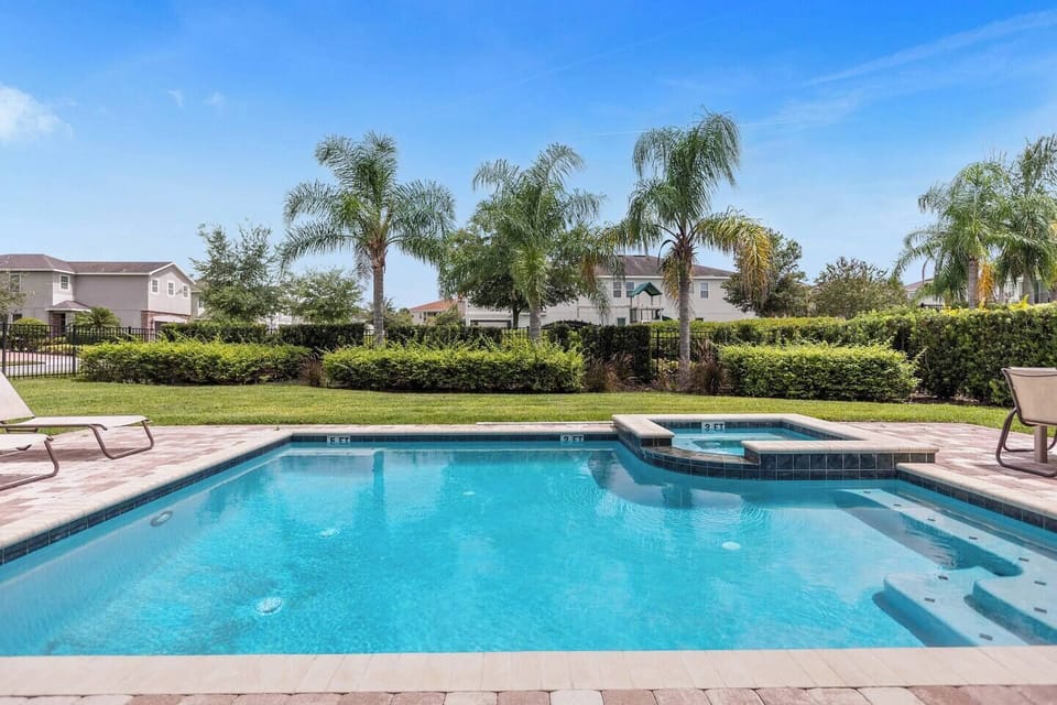 Inviting private pool and spa area surrounded by comfortable outdoor furniture, perfect for soaking up the sun or enjoying a relaxing evening under the stars.