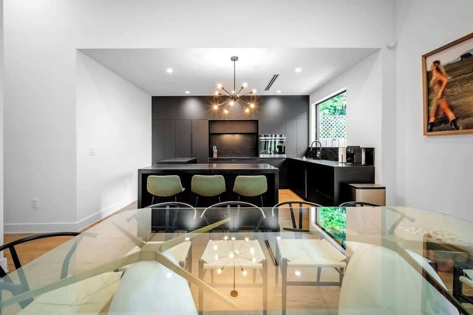 Cook, dine, and connect in this stunning open-concept space. The sleek, fully-equipped kitchen flows seamlessly into the elegant dining area, making it perfect for group meals and memorable conversations.
