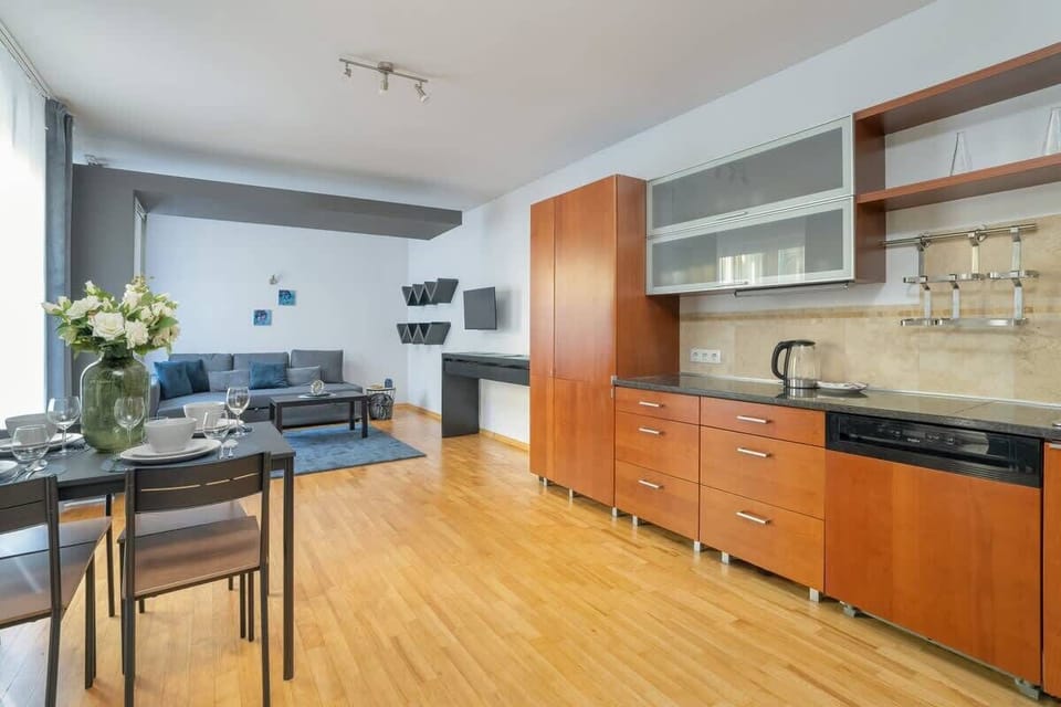 Spacious kitchen with wood cabinets and a dining area, providing a warm and inviting setup for cooking and dining.