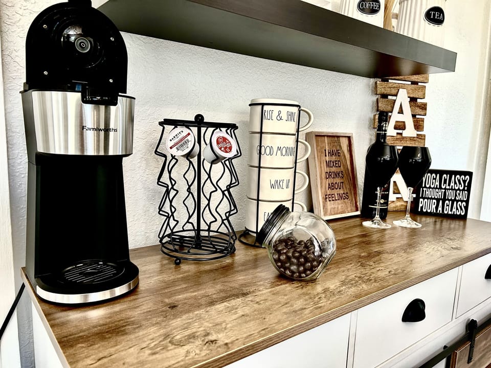 Coffee Bar. Hot or cold brew coffee maker. Utensils & kitchen supplies in bar.