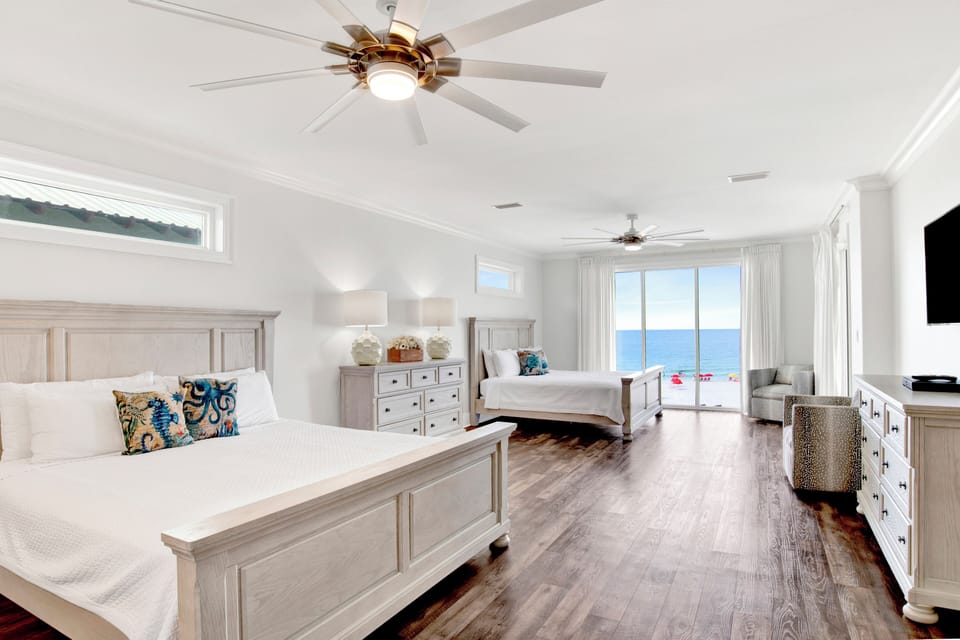 Bedroom 7 has a TV, balcony access, a private bathroom and two King beds, sleeps 4