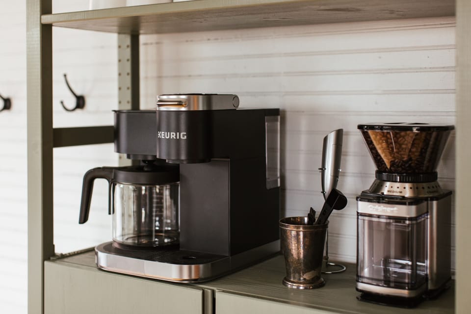Coffee, tea, cream and sugar are provided. There is a grinder available, as well as K-cups. You will also find a tea kettle and milk frother for your enjoyment!