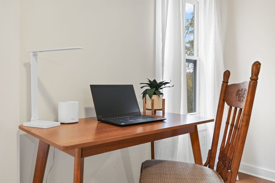Bedroom workspace with desk and natural light for remote work