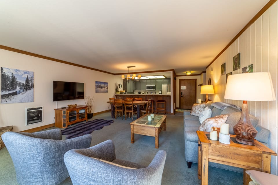 Open living room with large flatscreen TV.