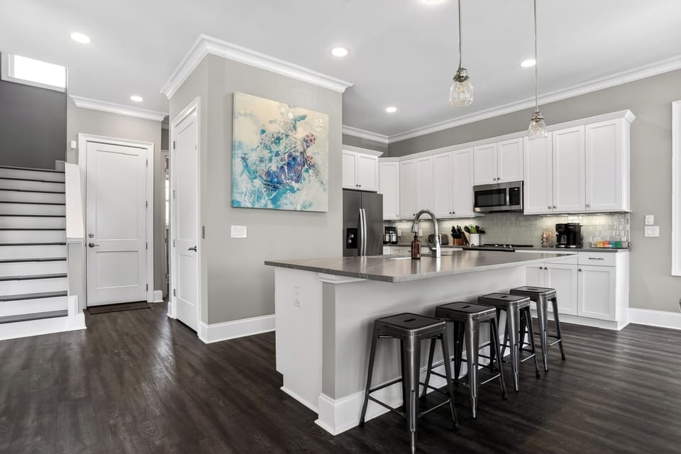 Fully equipped kitchen with barstool seating and a full suite of appliances.