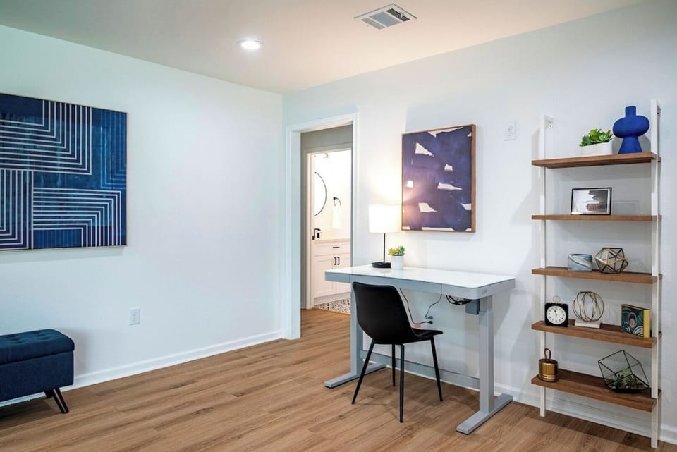 Just inside the front door is a coat closet and office area, complete with a height adjustable desk.