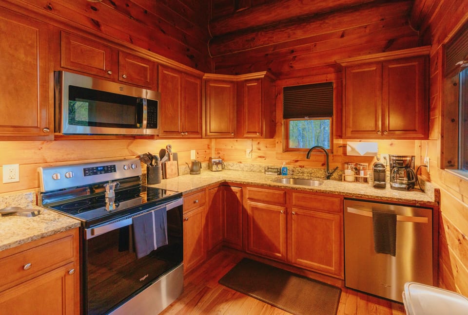 Explore your culinary skills in our well-equipped kitchen, furnished with cooking utensils, a dishwasher, and an ice maker, ensuring convenience and ease for your stay.