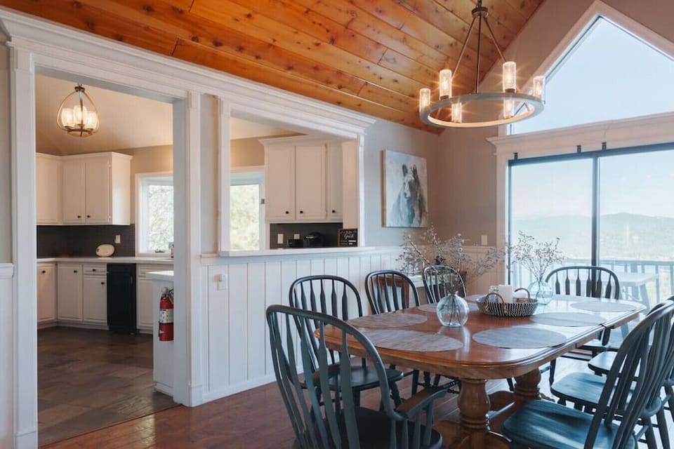 Dining room seats 8 with lake views and is open to the kitchen and living room