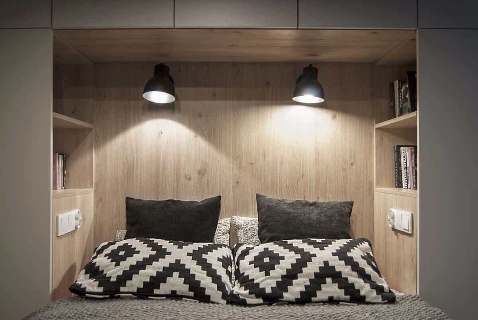 Another perspective of the bedroom nook, showcasing the warm wooden elements and soft lighting.
