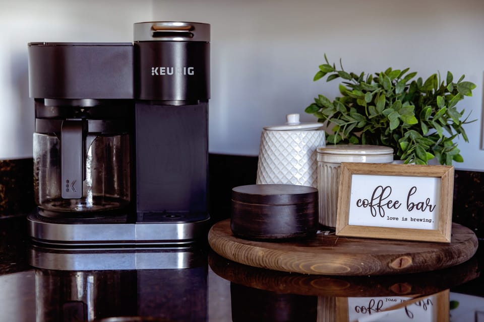 Keurig coffee maker brewing a fresh cup in a modern kitchen.