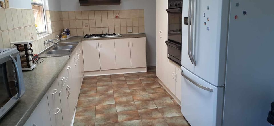 Kitchen with stove, oven, microwave, pots  and pans, plates cups etc.