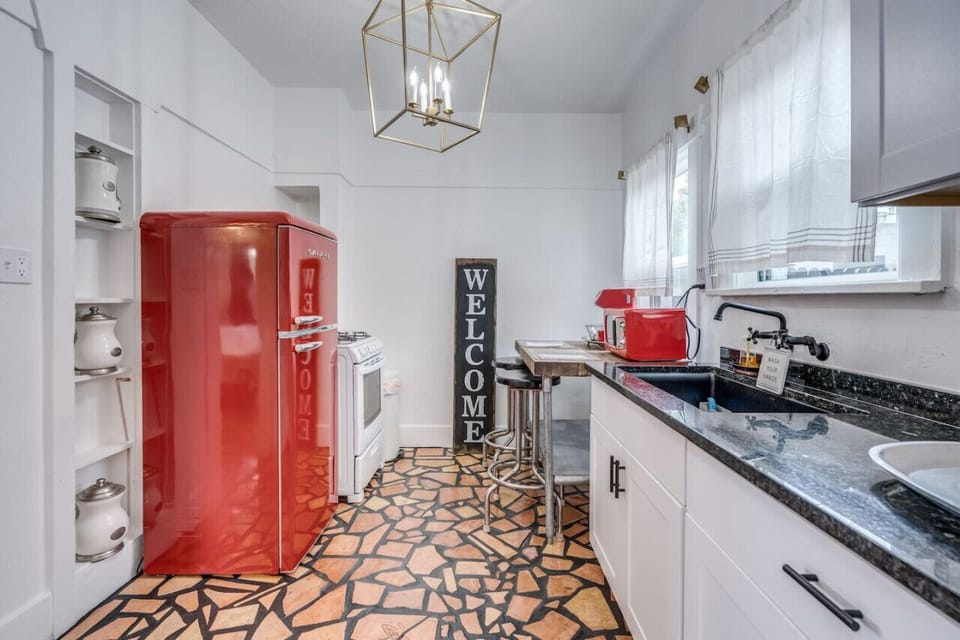 The updated kitchen has everything you need for at-home cooking, including a new retro gas stove and fridge. Enjoy your meal at the bar-top table.