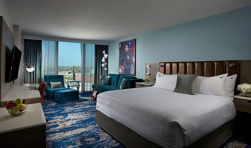 Stretch out on a king bed beside airy balcony doors.
