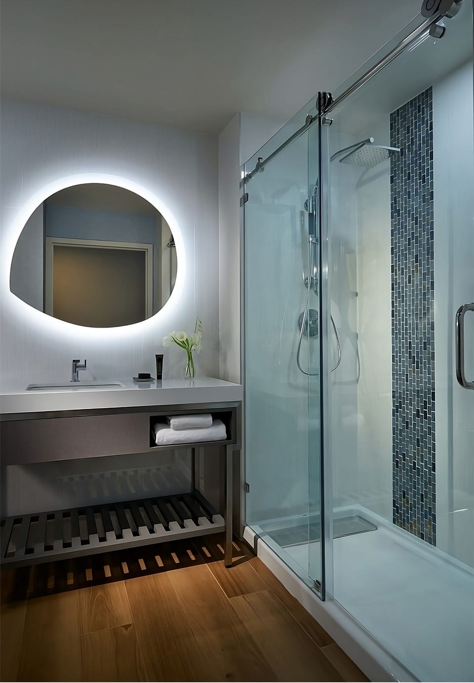 Refresh under a rainfall shower beside a glowing mirror vanity.