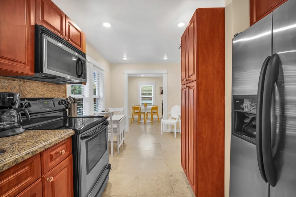 Unleash your inner chef in our newly renovated kitchen, thoughtfully equipped with the essentials, a spacious full-size refrigerator, and an abundance of storage spaces.