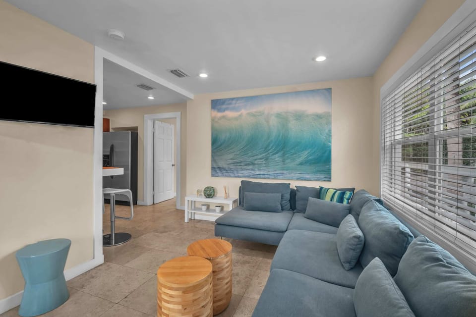 Unwind in a charming and laid-back living space, complete with a comfortable sofa and a spacious TV for your enjoyment.