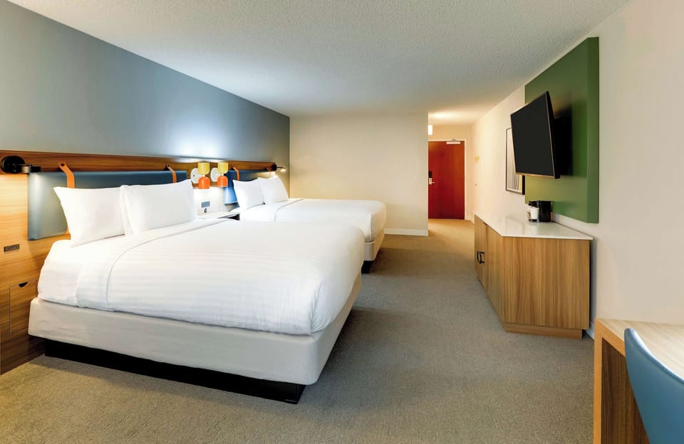 Settle in with roomy walkways, bedside lighting, and modern style.