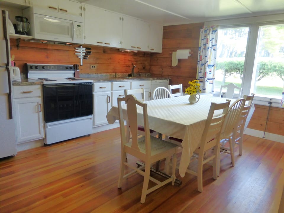 The kitchen table seats 8 and a smaller table seats 4 more.