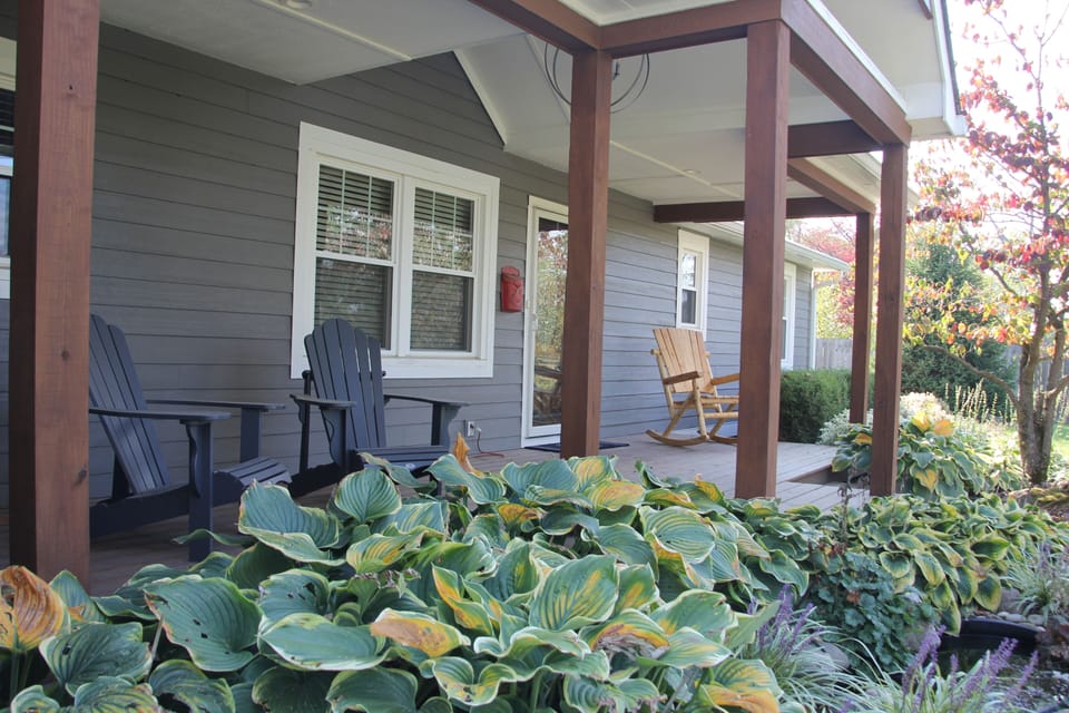 Front porch with Adirondack chairs and oversized rocking chair