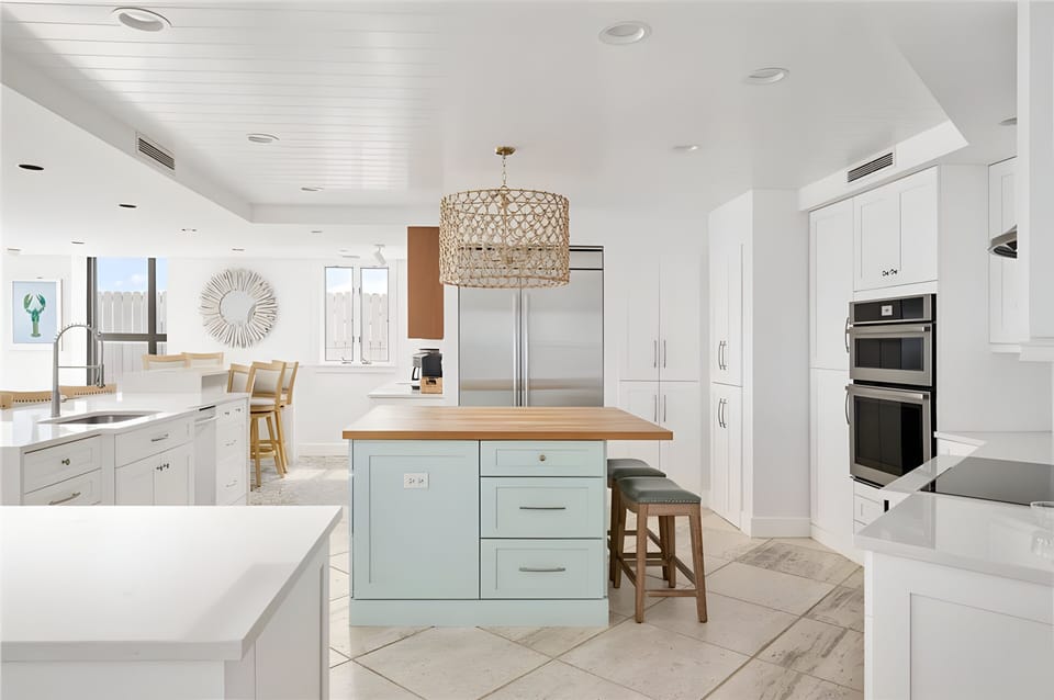 Chefs dream kitchen with two ovens, conduction cooktop and large refrigerator.  