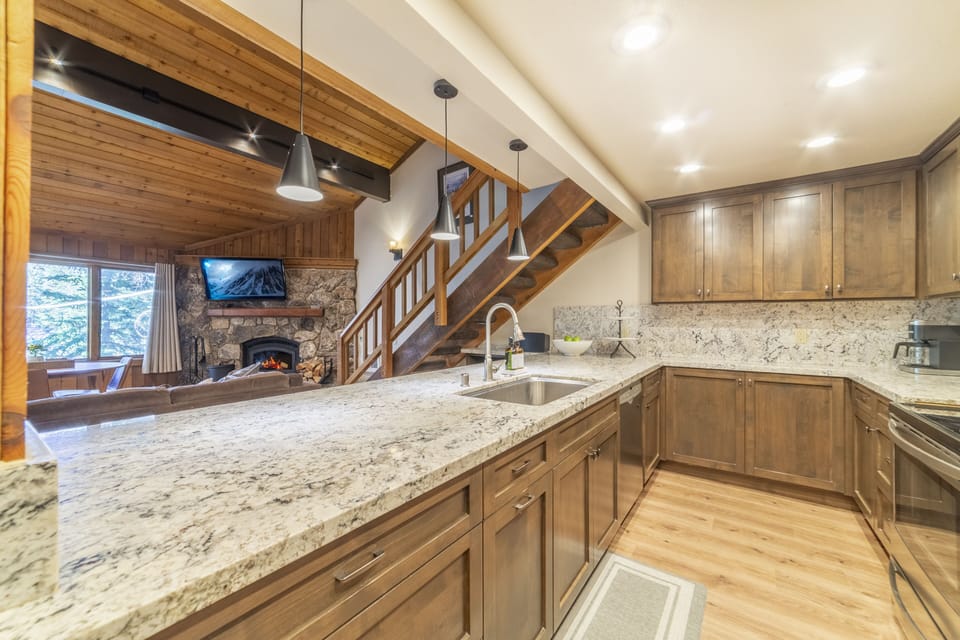 Fully stocked kitchen with quartz counters and stainless appliances. 