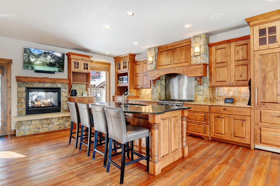Bar Seating for 4 at Custom Kitchen Island With 50" HDTV and Double Sided Fireplace