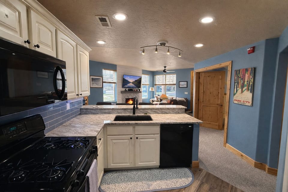 Functional kitchen layout keeps everyone connected while cooking, dining, and relaxing.