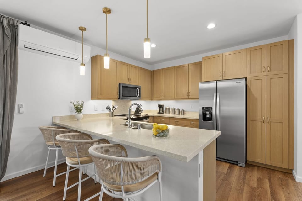Additional barstool seating at the kitchen counter.