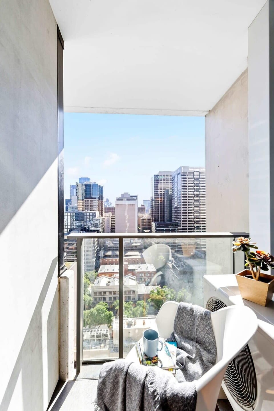 A balcony with city views. (chair on balcony is from the dining area)