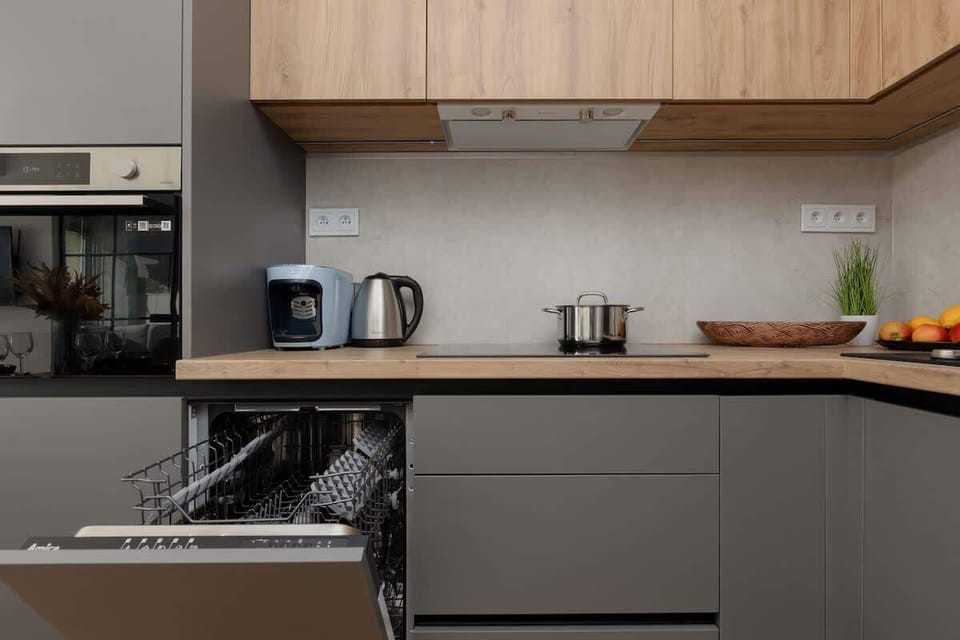A fully equipped kitchen featuring built-in appliances, a dishwasher, and an organized workspace.
