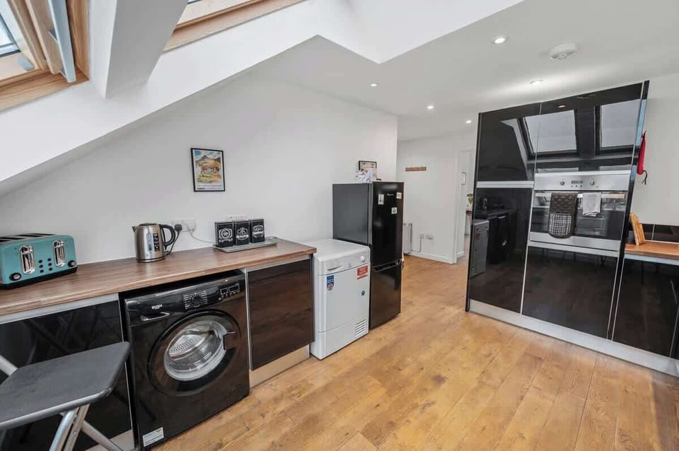 Modern kitchen stocked with everything needed to enjoy a home-cooked meal and a washing machine