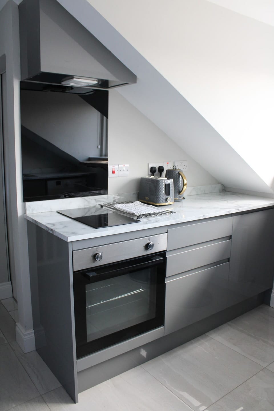 Kitchen area - includes hob, oven, fridge and washing machine