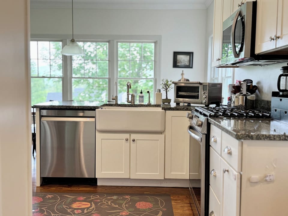 The kitchen has stainless appliances, a gas oven, and all the essentials.
