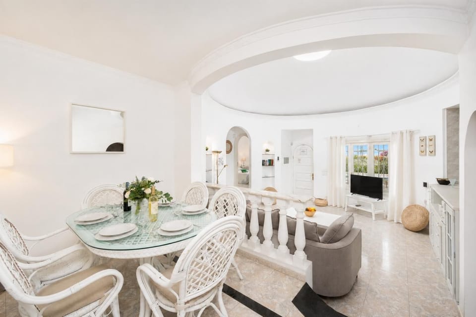 Open-plan living room with sofa, dining area, kitchen, WiFi internet, and satellite TV