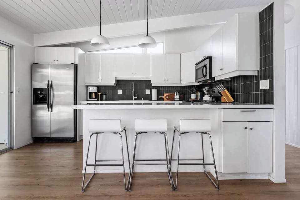 Fully-stocked kitchen along with some bar chars to hang out with chef of the group!