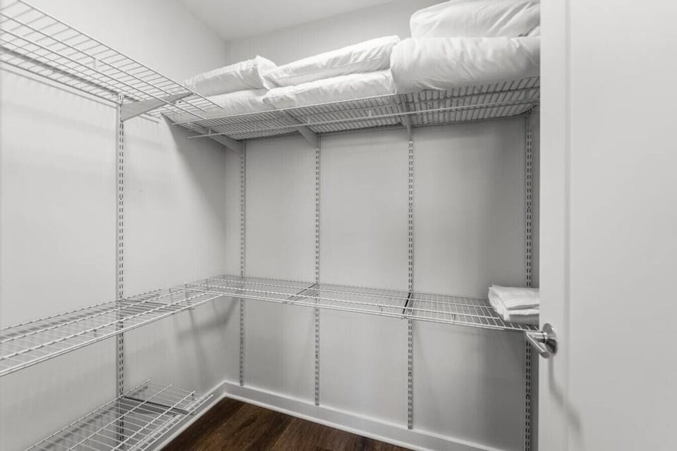 Extra large closet in bedroom with linens for pullout