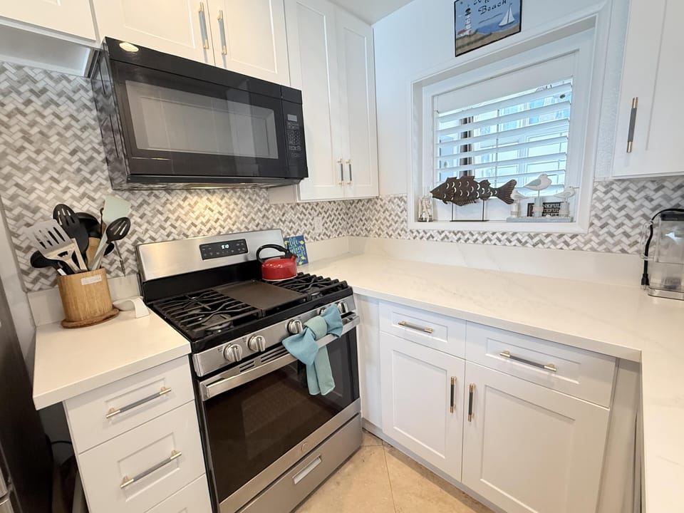 Bright, modern kitchen with sleek appliances and stylish backsplash