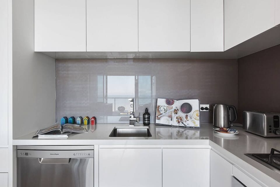 A fully-equipped kitchen boasts contemporary appliances including a gas stove, state-of-the-art oven, full-sized fridge and dishwasher.