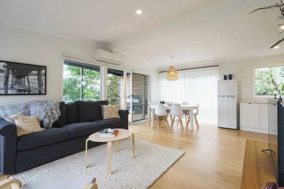Guests can settle in on the sofa with a book in the light and airy living area.  
