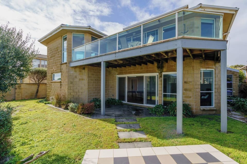 The pet-friendly backyard ensures everyone has plenty of space to play, relax, and entertain. 
