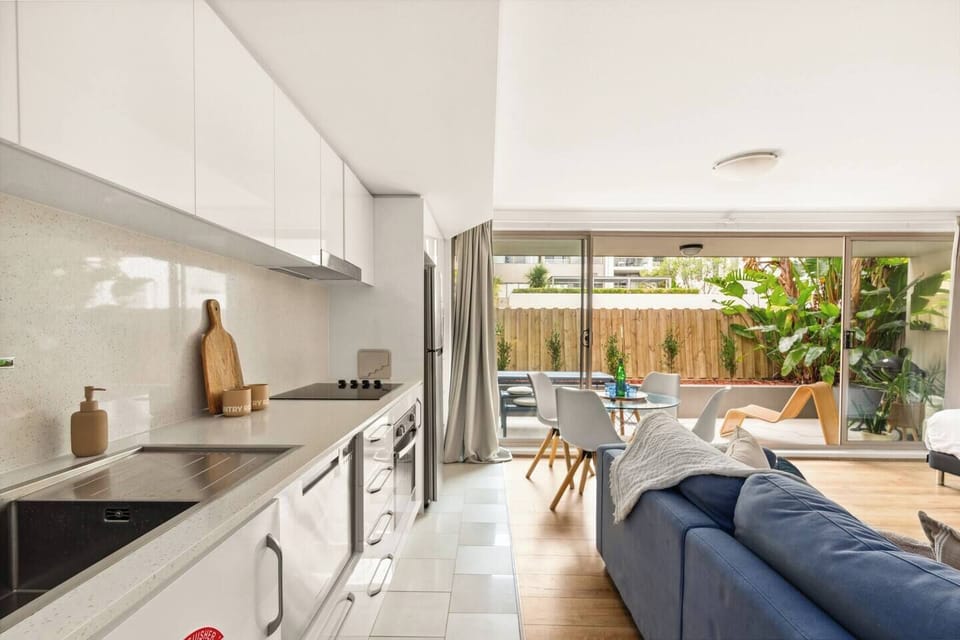 The open-plan living area effortlessly connects the kitchen and dining areas, creating a harmonious living space for you to enjoy.