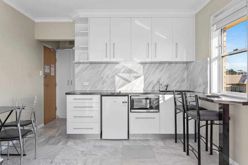 The kitchenette has an induction stove, microwave and bar fridge for easy meals at home. 
